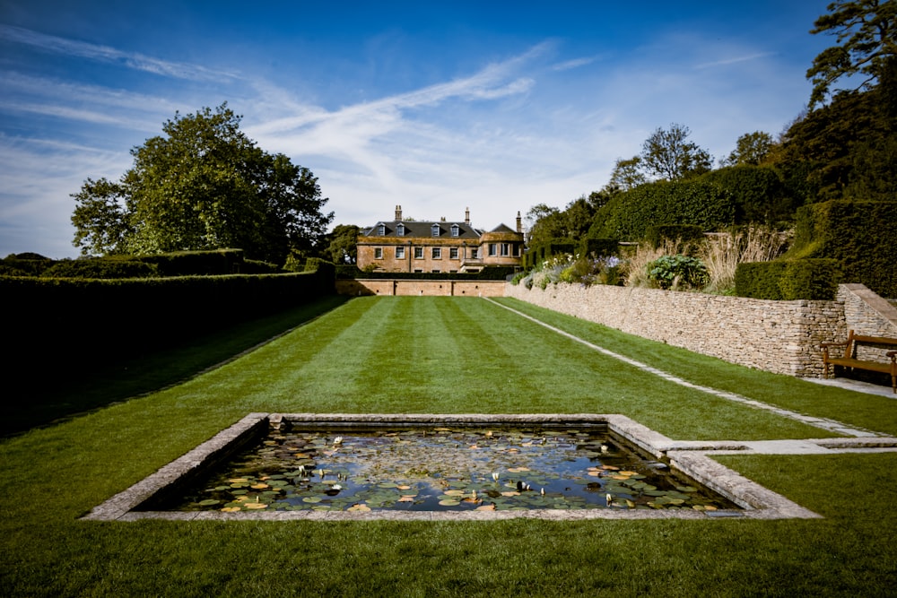 a lawn with a pond in the middle of it