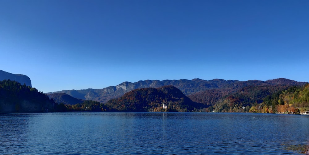 a body of water with mountains in the background