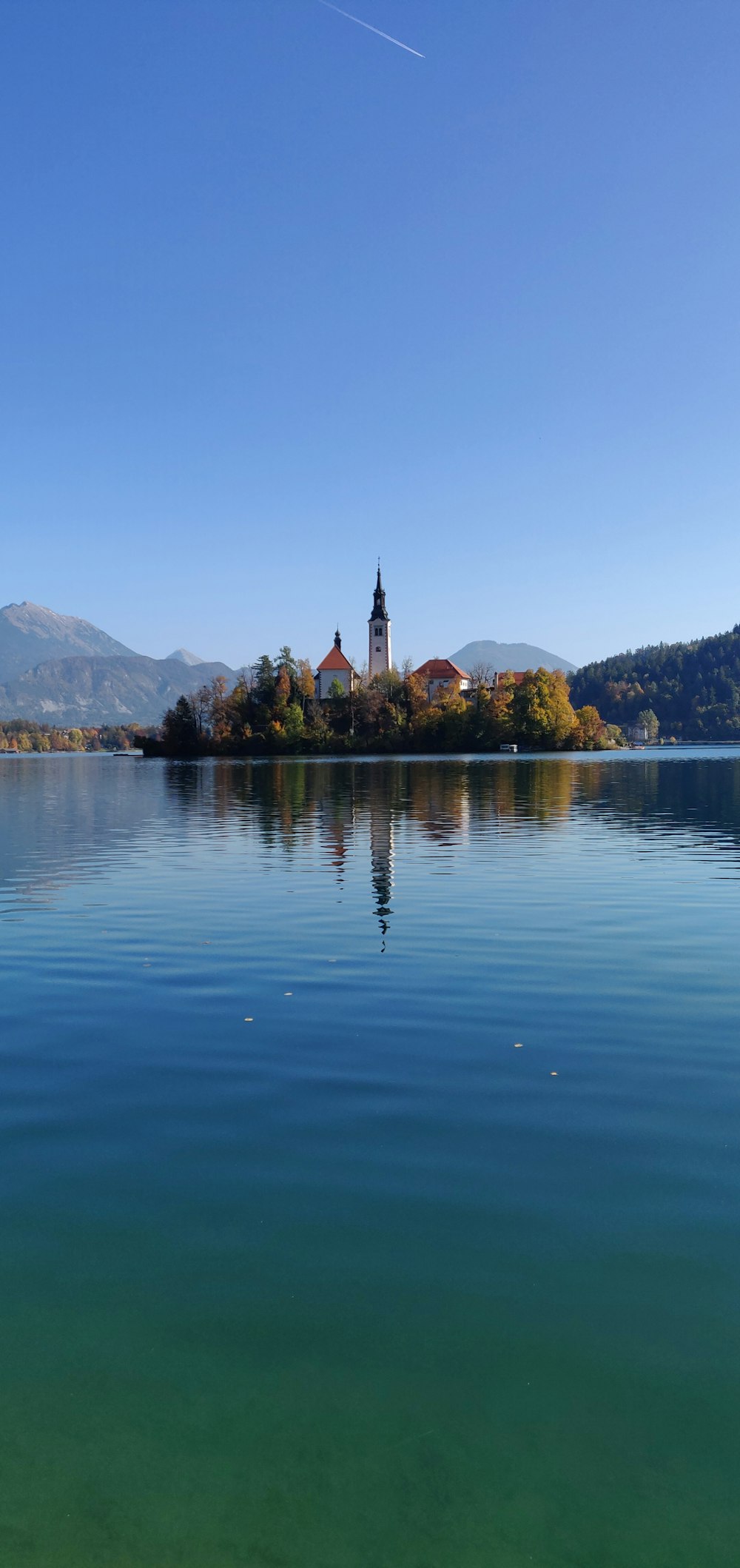 a small island with a church in the middle of a lake