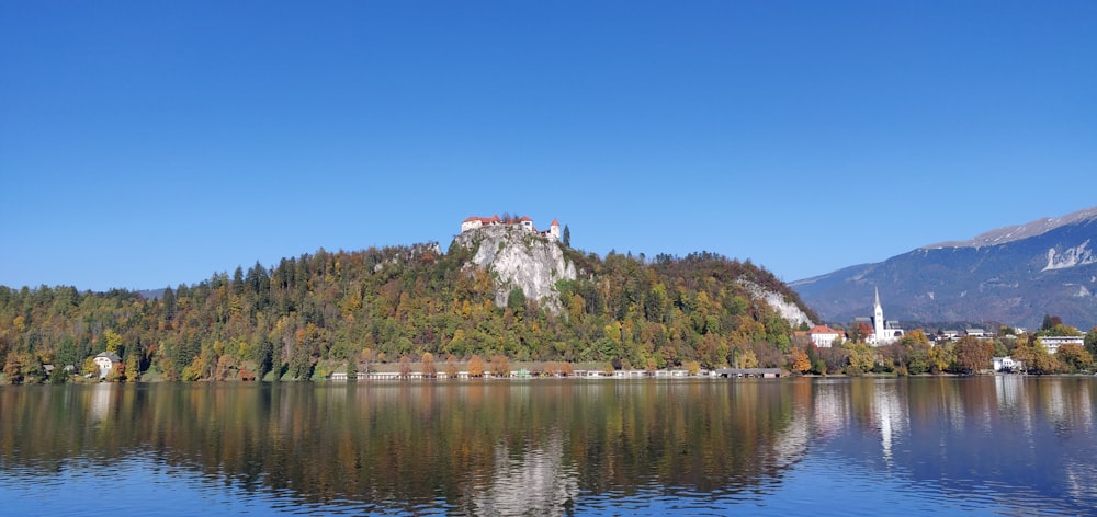 a lake with a castle on a hill in the background