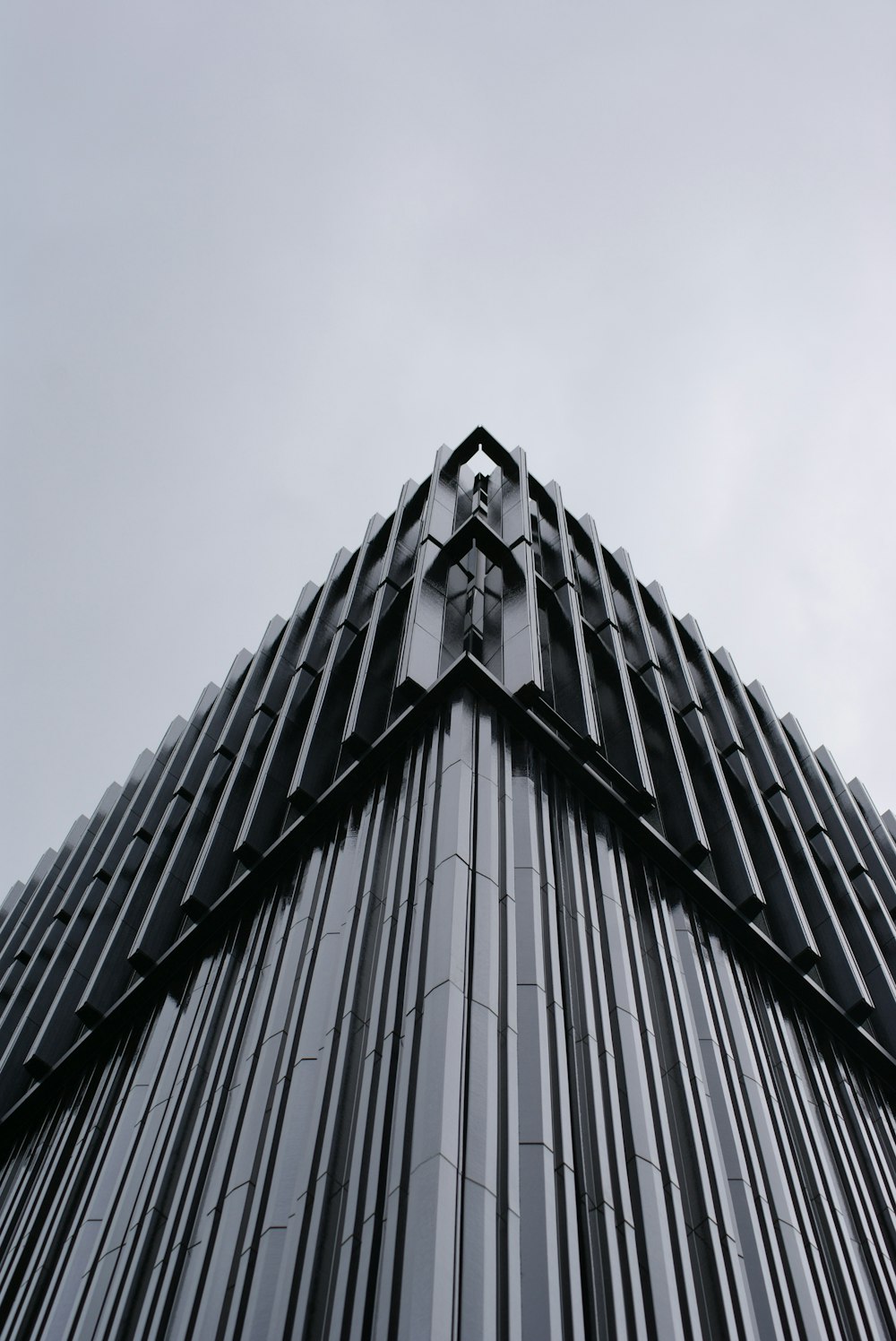 a tall black building with a sky background