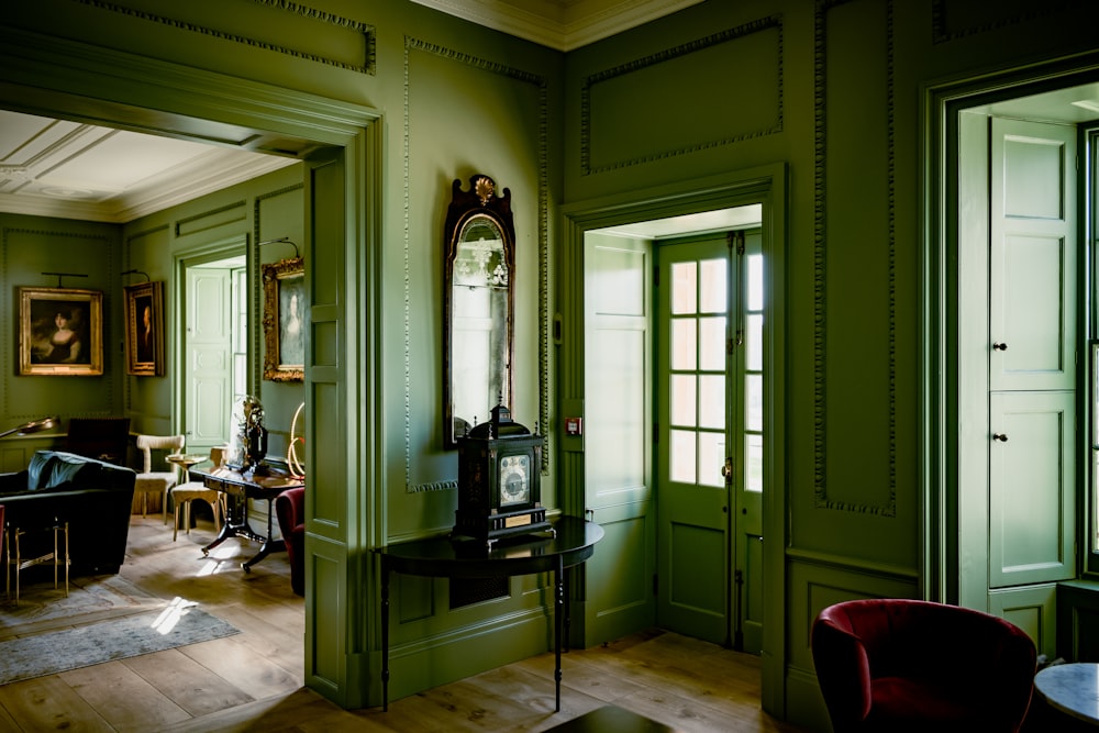 a room with green walls and wooden floors
