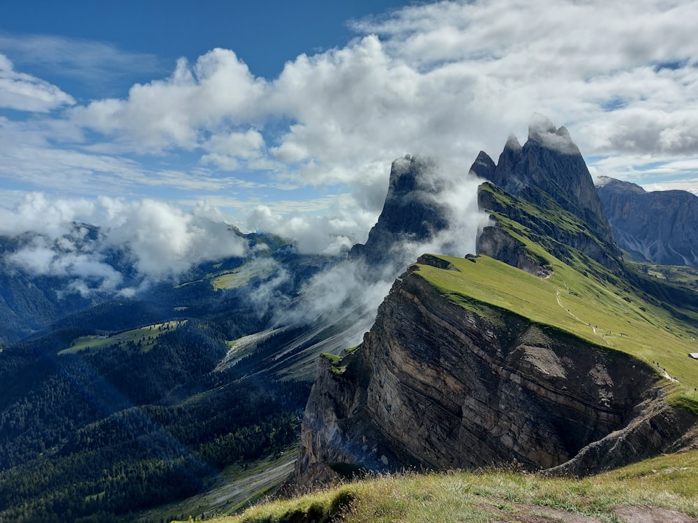 a view of a mountain range with clouds in the sky