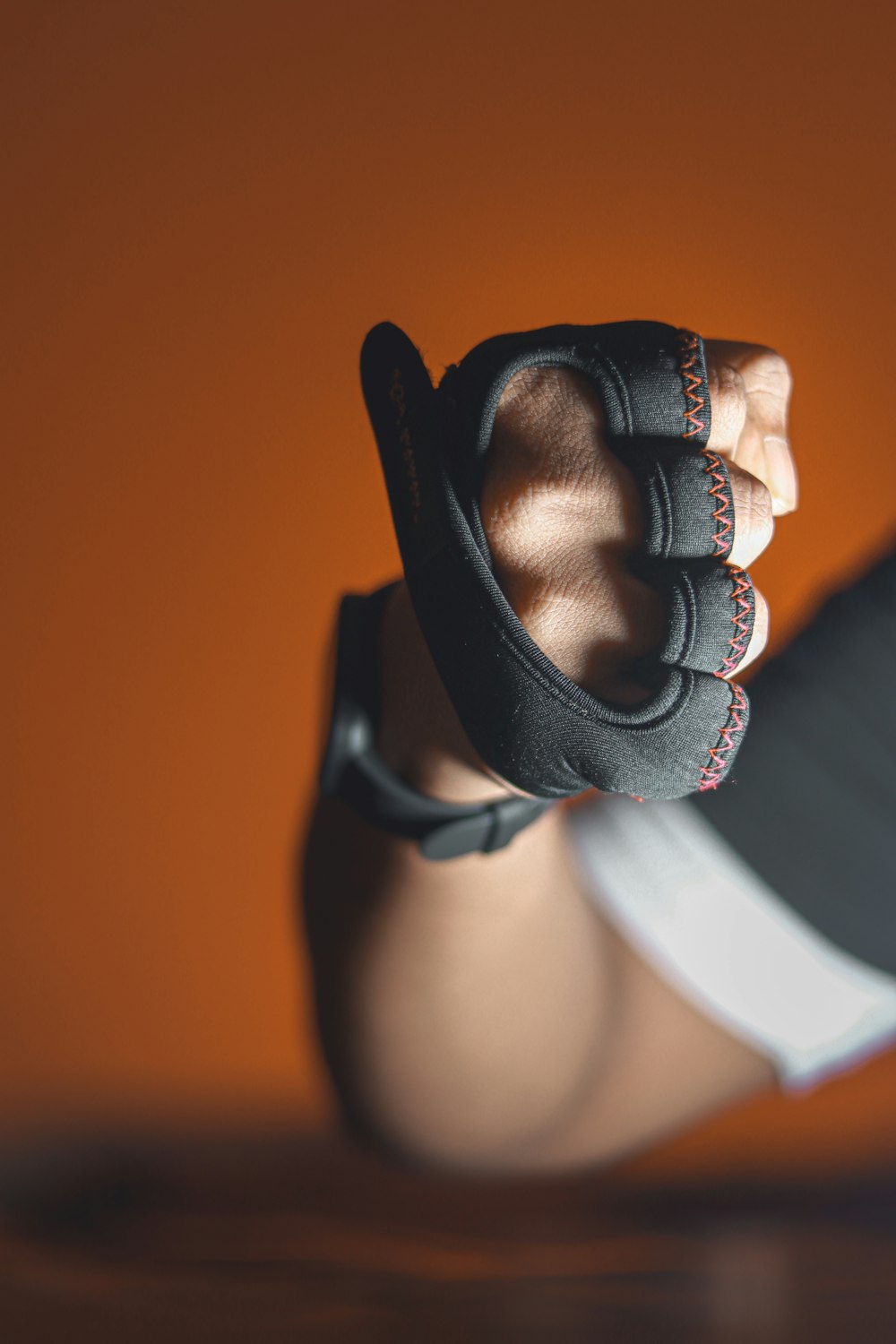 a close up of a person holding a pair of gloves