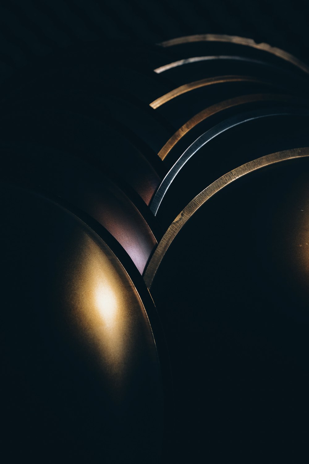 a row of shiny round lights in a dark room