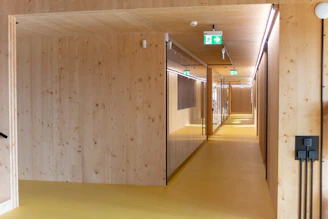 a long hallway with wooden walls and a clock on the wall