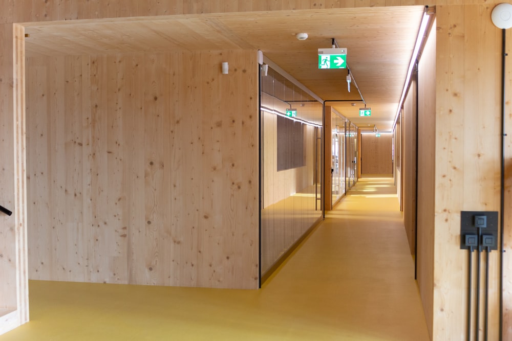 a long hallway with wooden walls and a clock on the wall