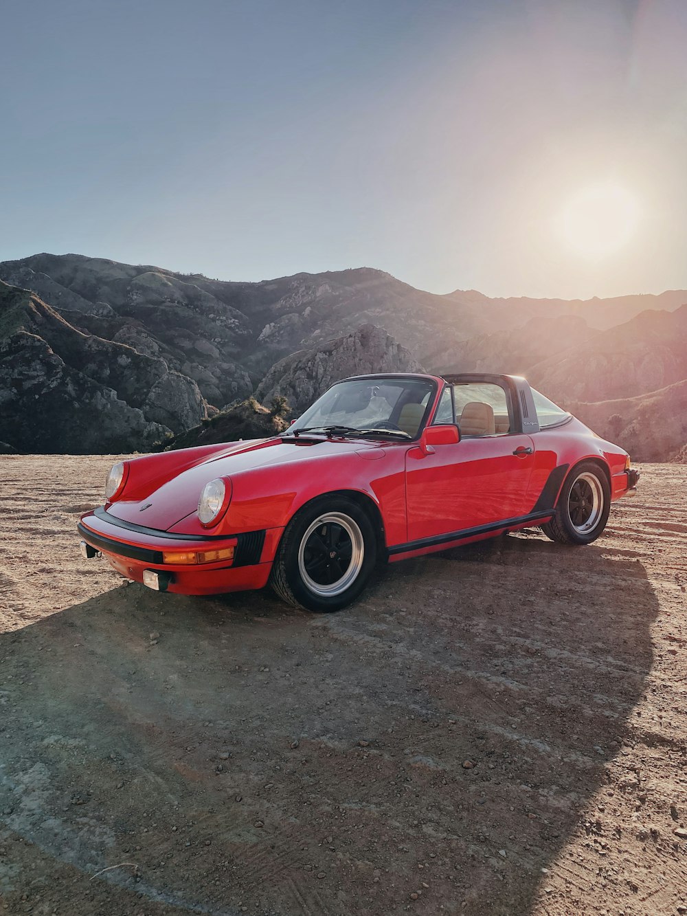 a red sports car parked in the desert