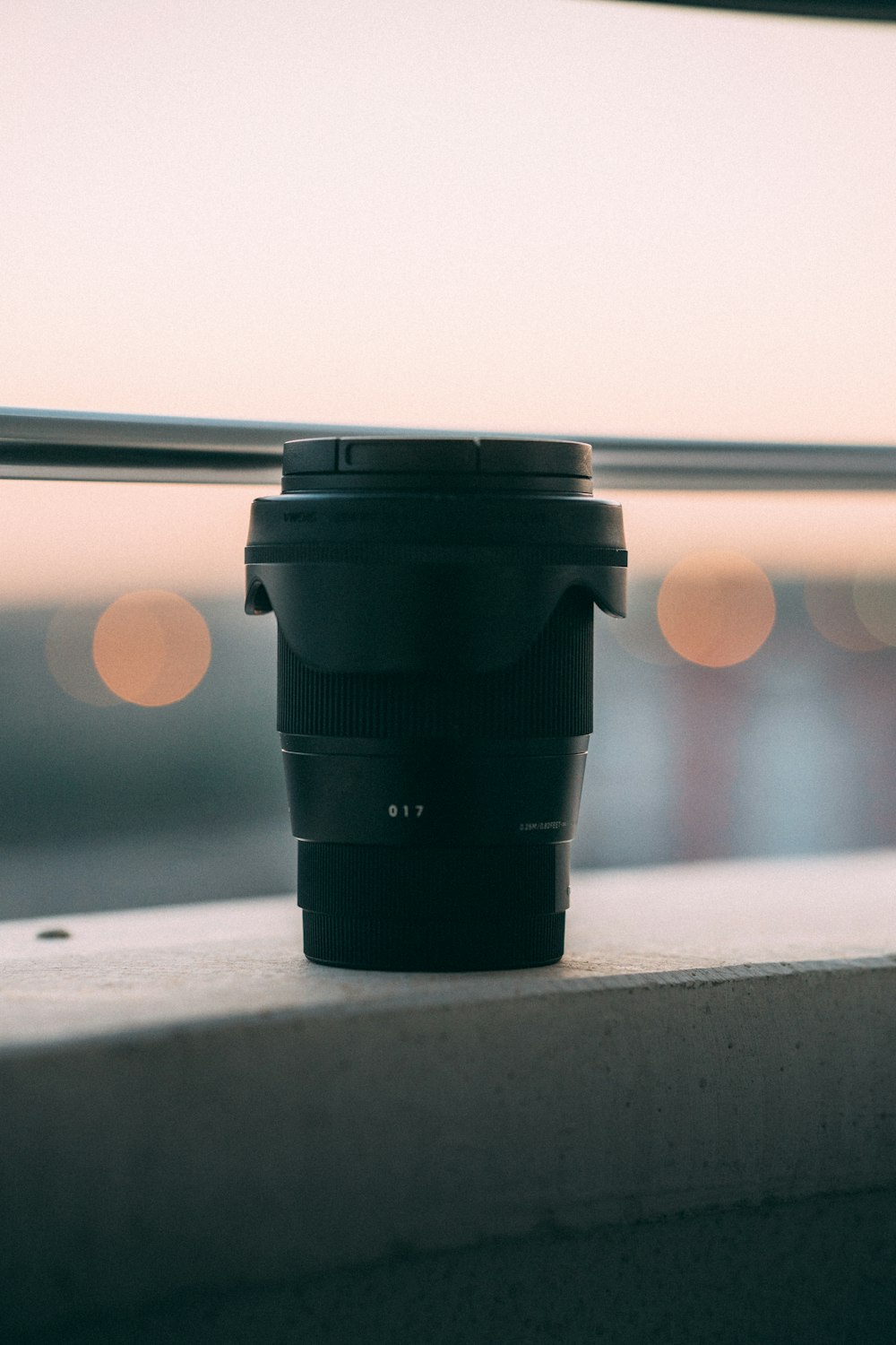 a camera lens sitting on top of a window sill