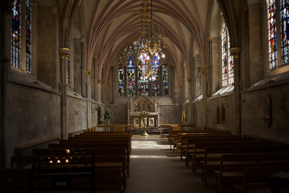 a church with stained glass windows and pews