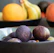 a bowl of fruit sitting on top of a wooden table