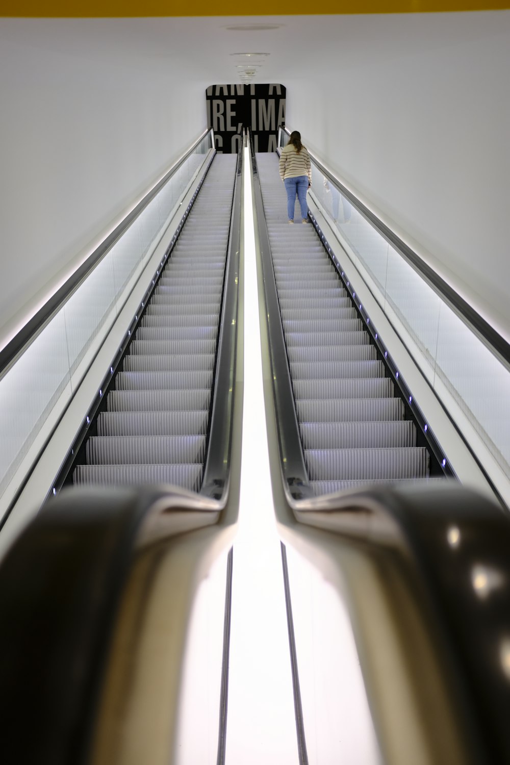an escalator in a building with people on it