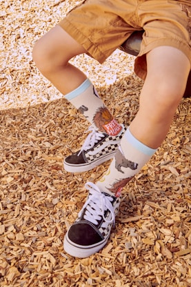 a young boy wearing a pair of black and white shoes