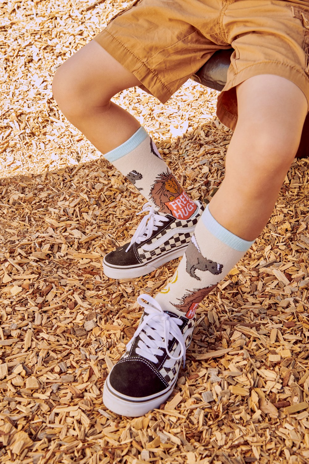 a young boy wearing a pair of black and white shoes