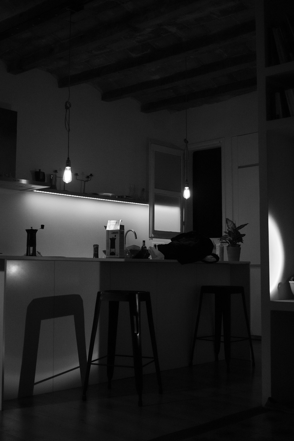 a black and white photo of a kitchen