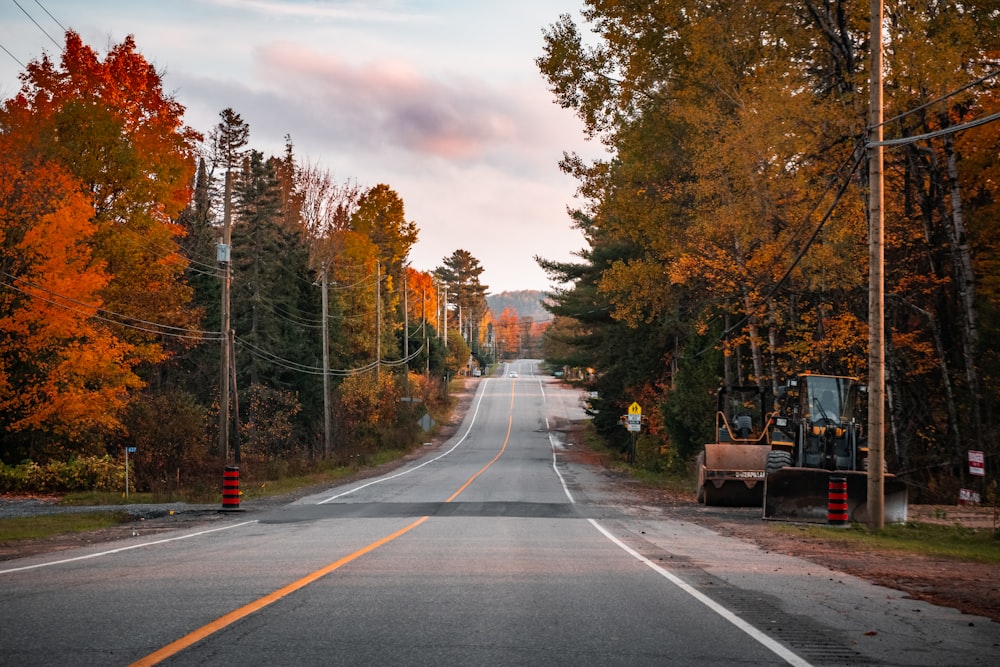 an empty road with a bulldozer in the middle of the road