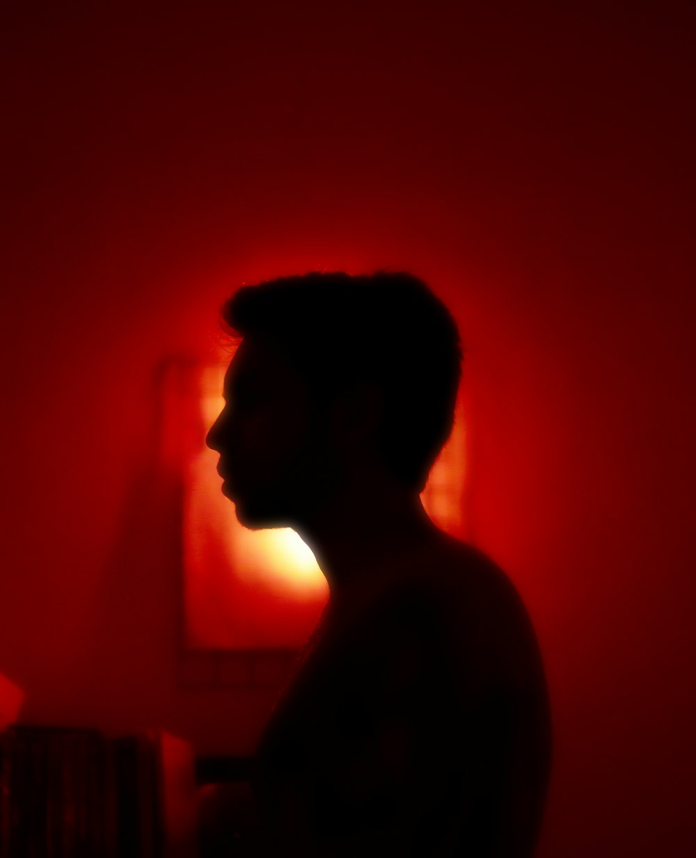 a silhouette of a man in a red room