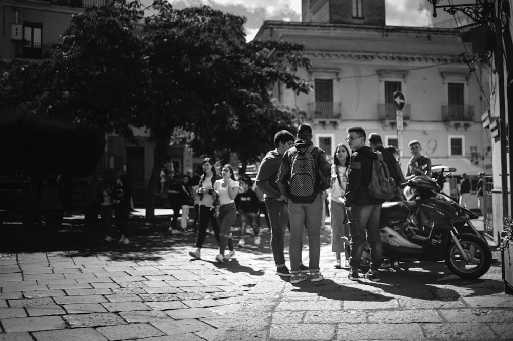 a group of people standing around a motorcycle