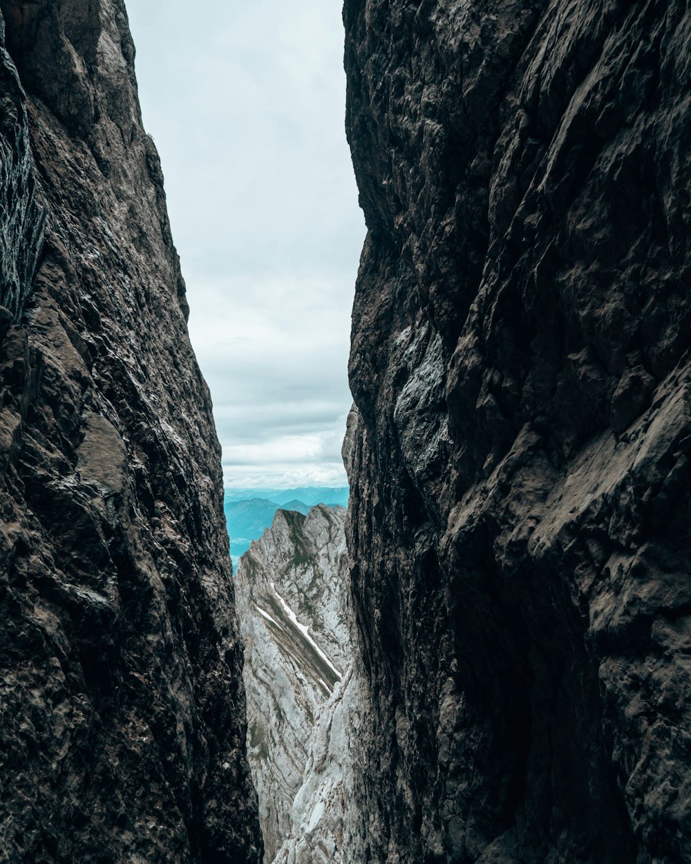 a person standing in a narrow canyon between two mountains