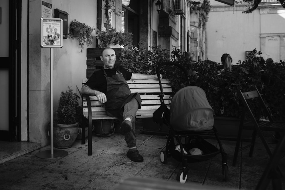 a man sitting on a bench in front of a building