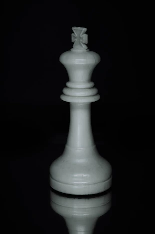 a white chess piece sitting on top of a table
