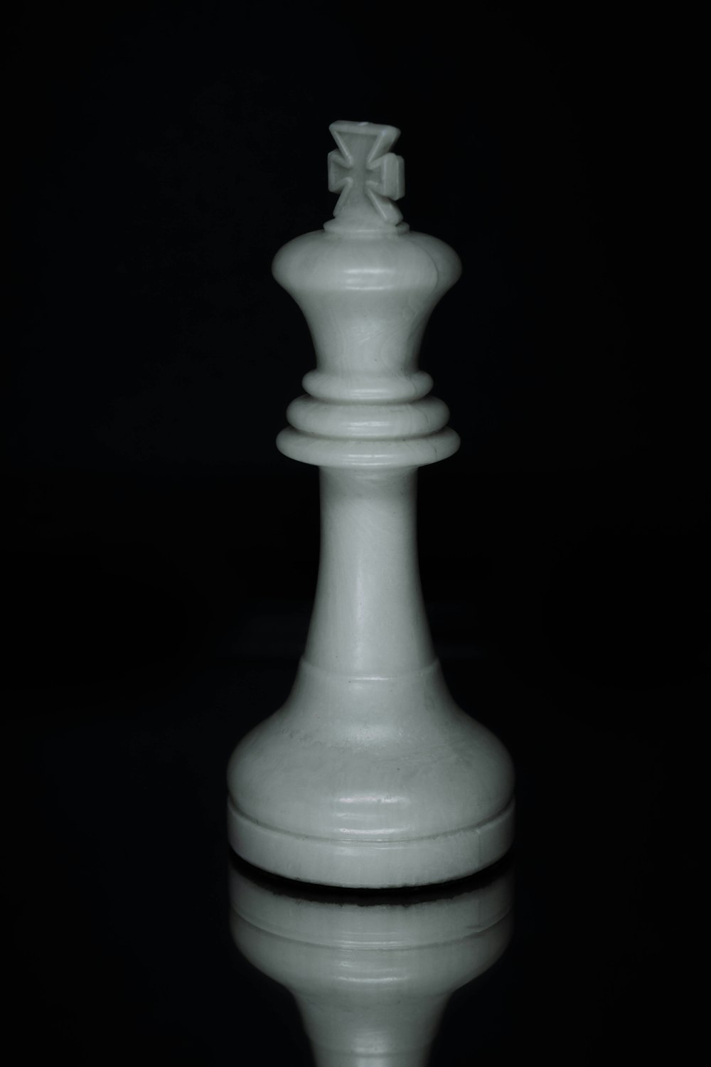 a white chess piece sitting on top of a table