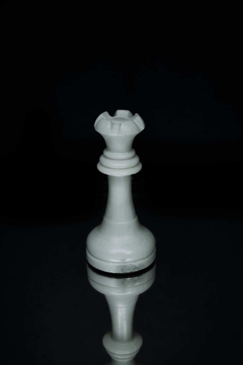 a white chess piece sitting on top of a table