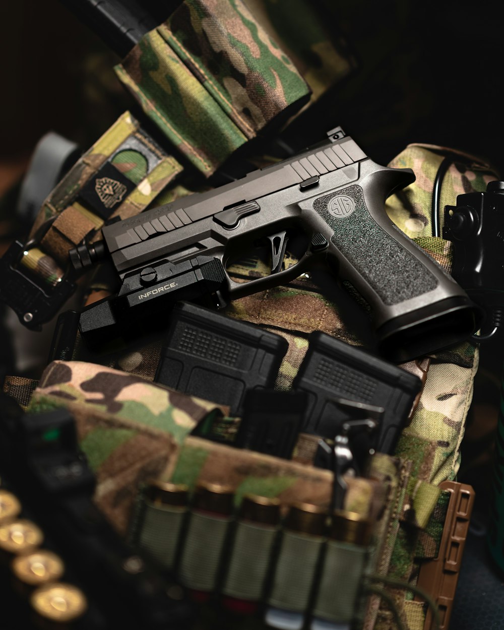 a close up of a gun on a camouflage bag