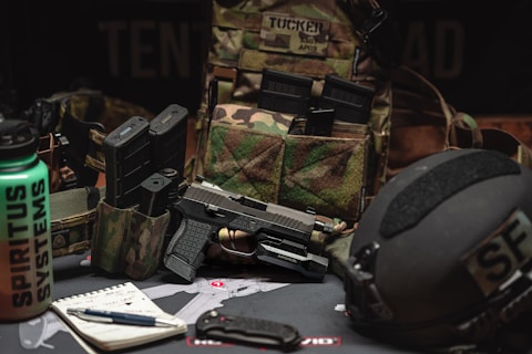 a gun, helmet, and other items laid out on a table