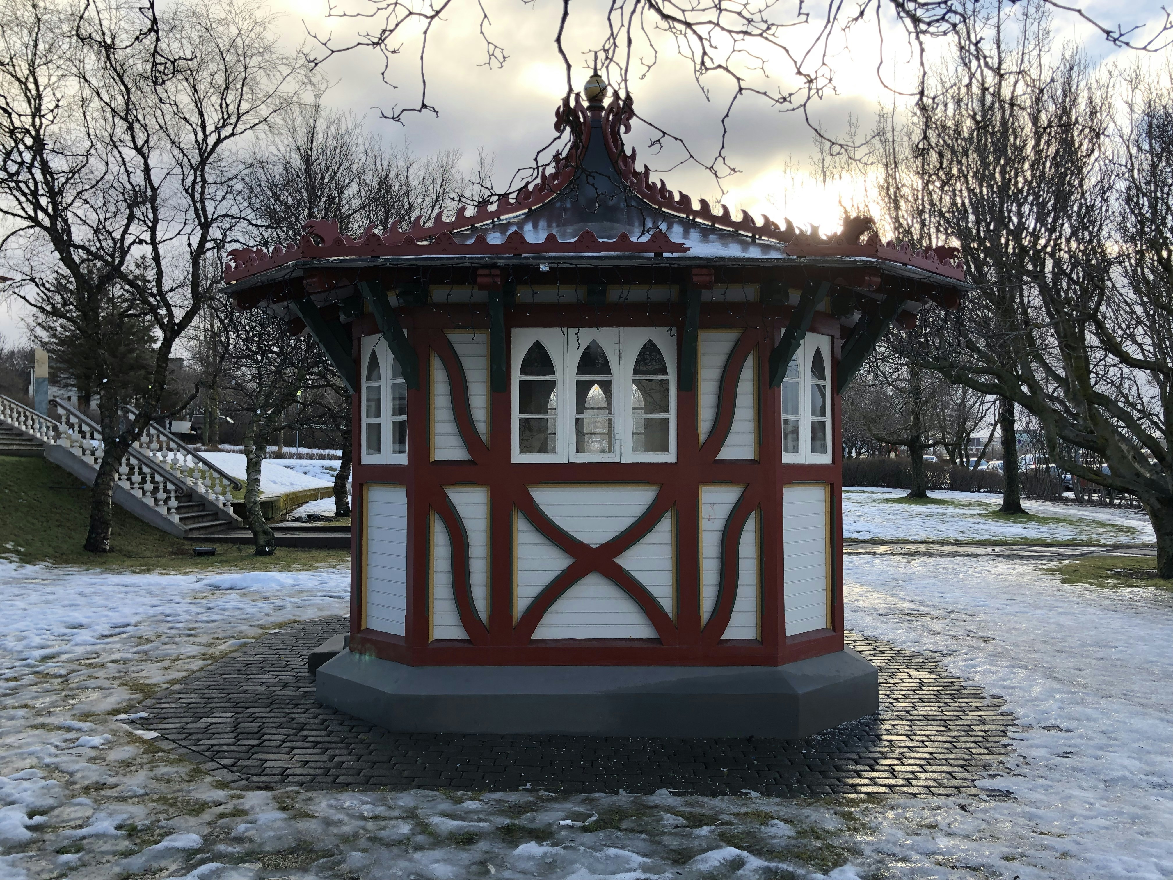 a small red and white building in the snow