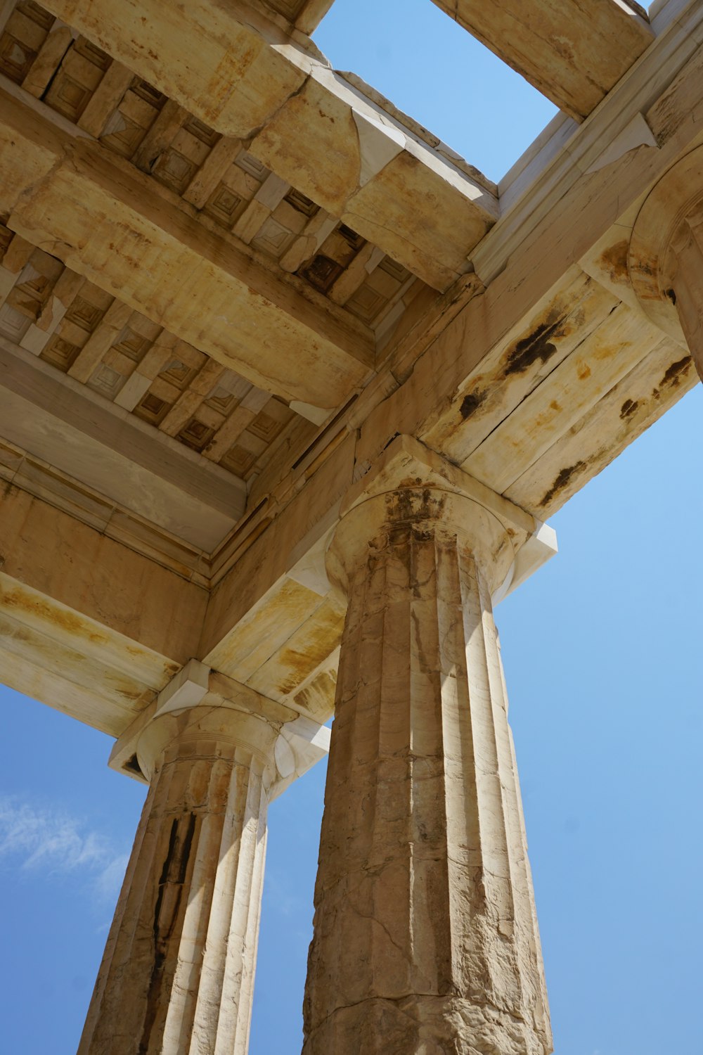 the columns of a building with a blue sky in the background