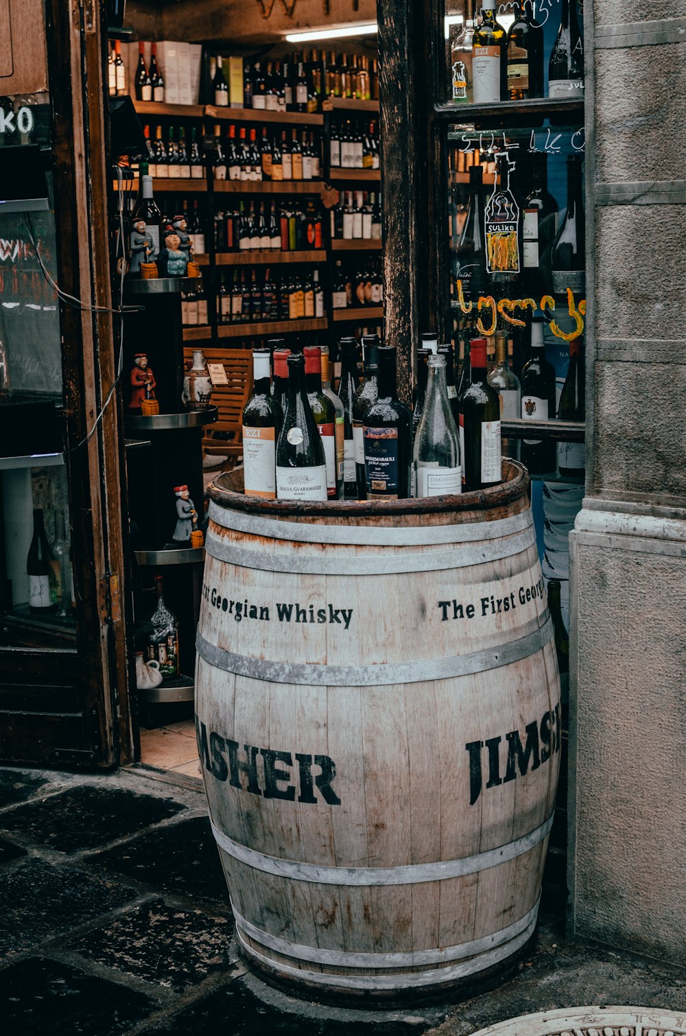 a wooden barrel filled with bottles of wine