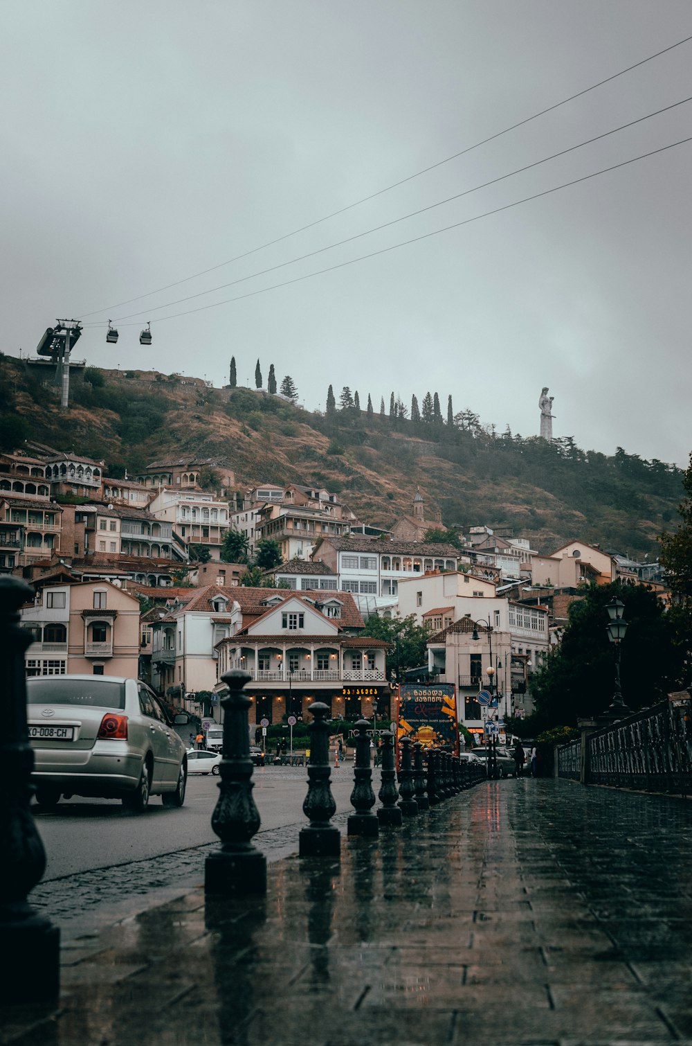 a city street with a hill in the background