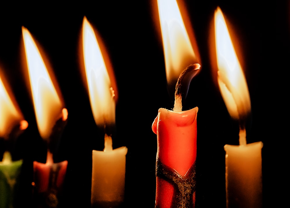 a group of lit candles sitting next to each other