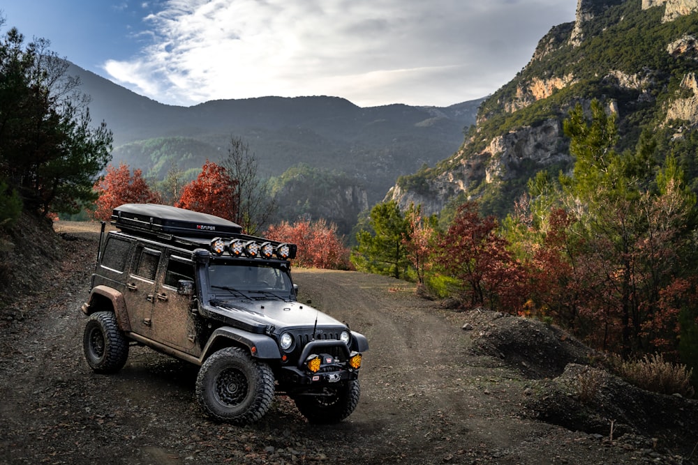 a jeep parked on the side of a dirt road