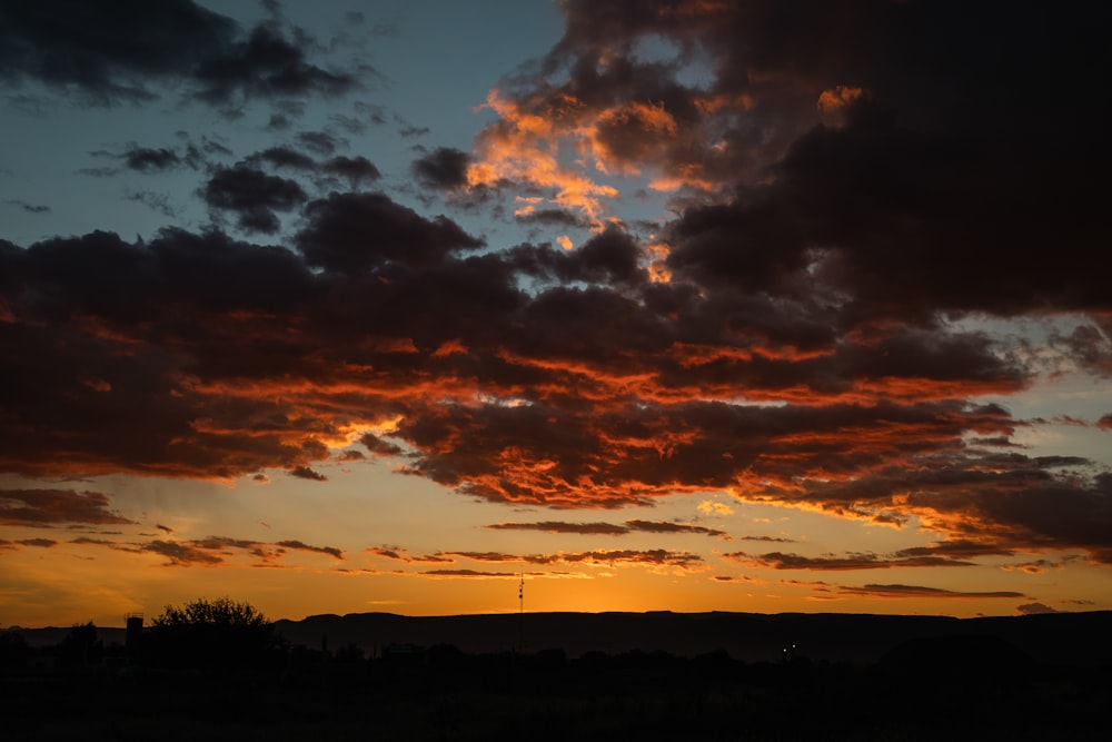 the sun is setting over a mountain range