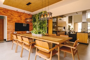 a dining room with a wooden table and chairs