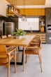 a kitchen with wooden cabinets and a dining room table