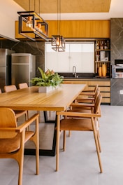 a kitchen with wooden cabinets and a dining room table