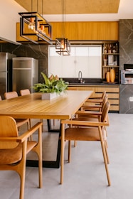 a kitchen with wooden cabinets and a dining room table