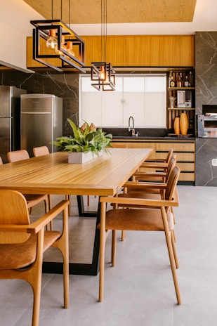 a kitchen with wooden cabinets and a dining room table