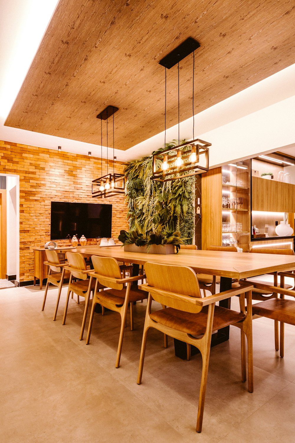 a dining room with a wooden table and chairs