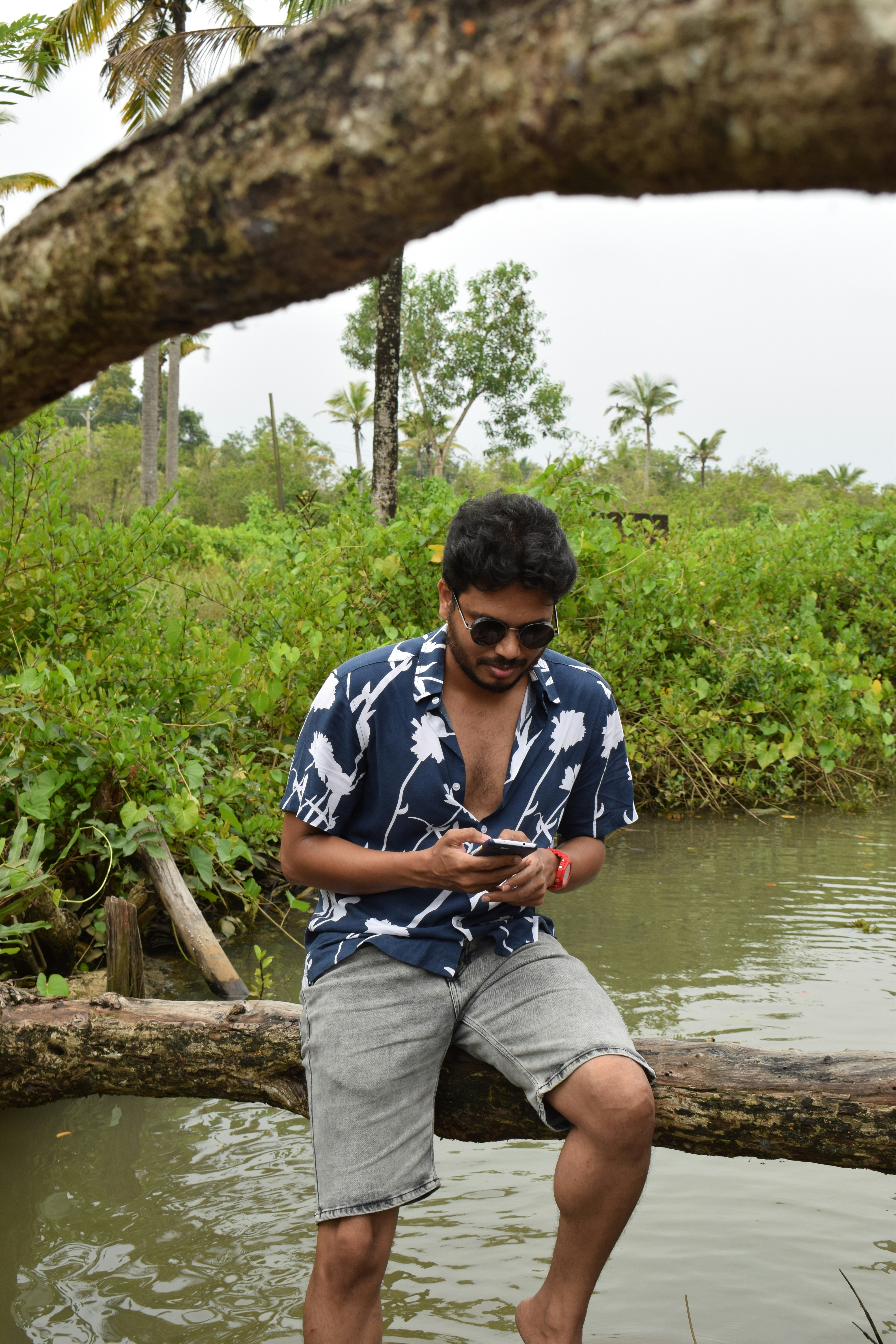 a man sitting on a log in the water