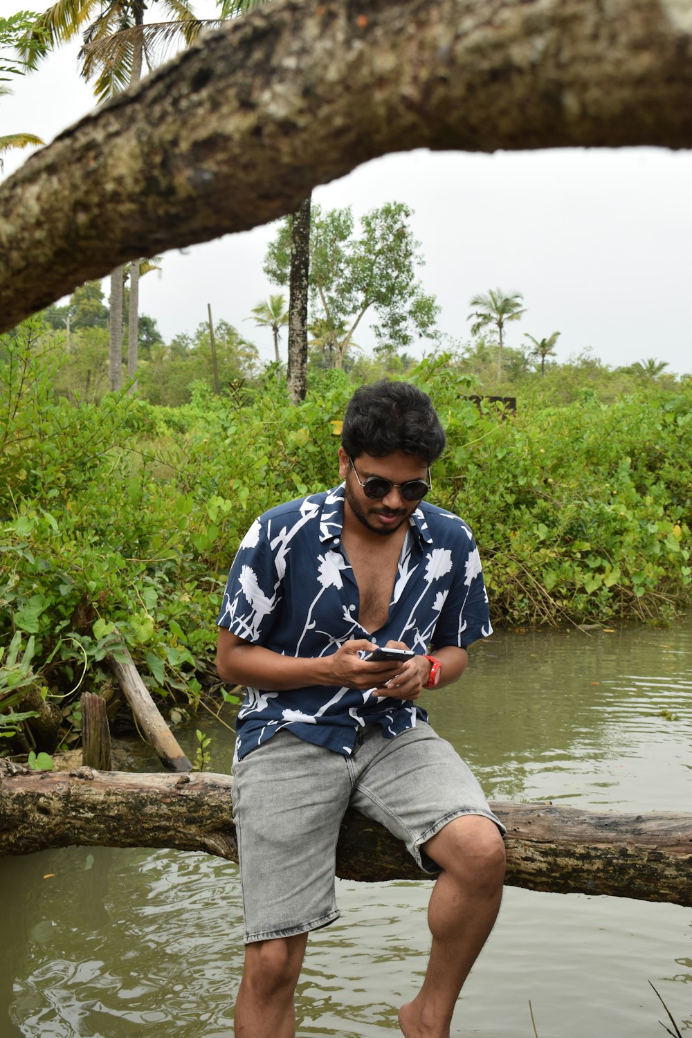 a man sitting on a log in the water