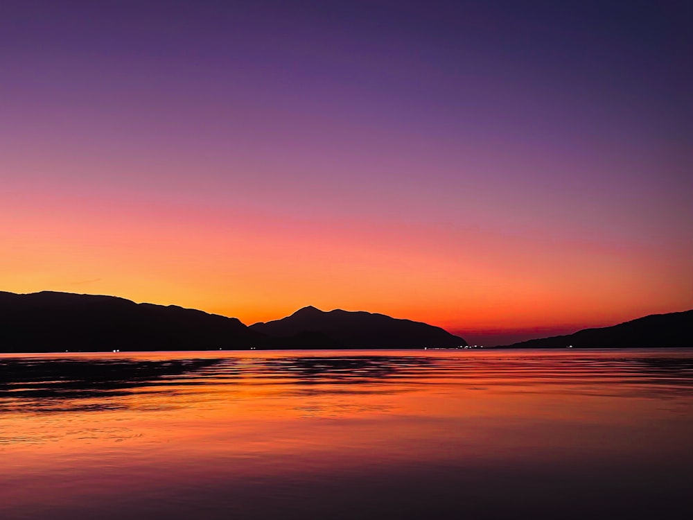 a beautiful sunset with mountains in the background