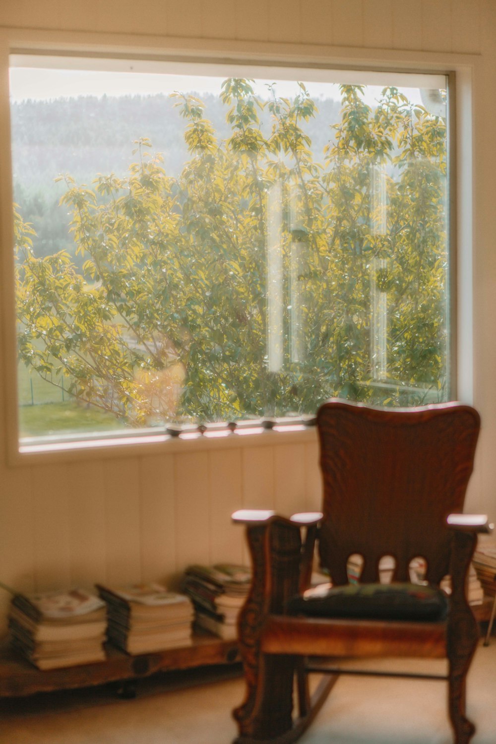 a rocking chair sitting in front of a window