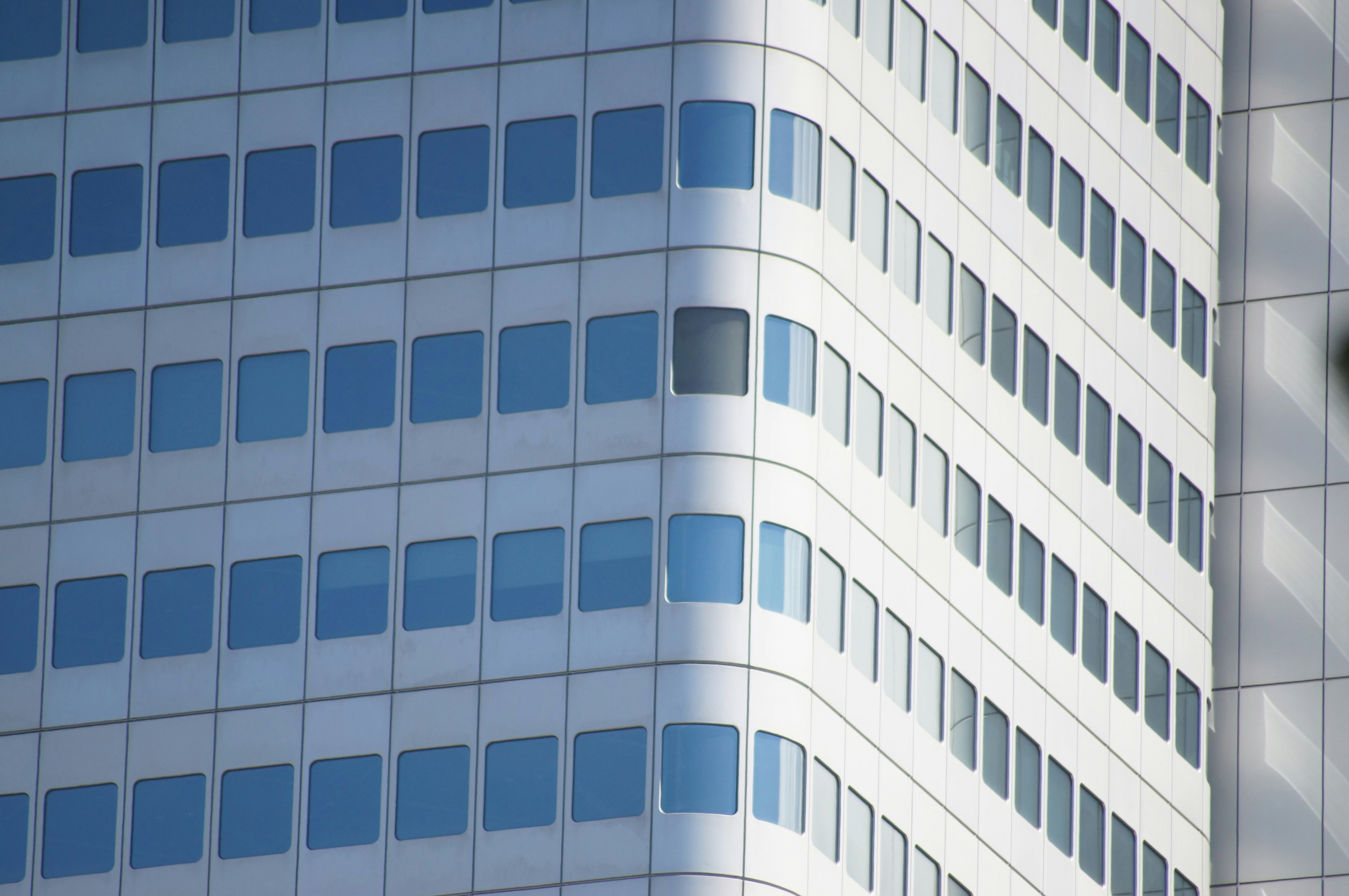 A tall white building with lots of windows