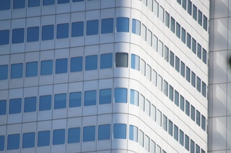 a tall white building with lots of windows