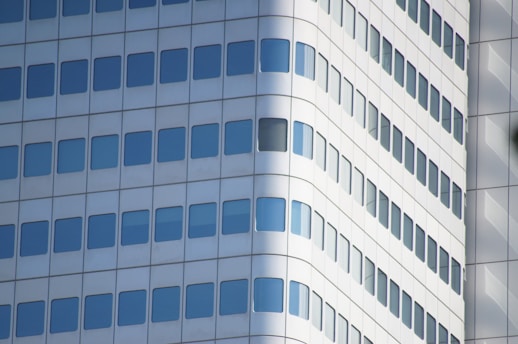 a tall white building with lots of windows