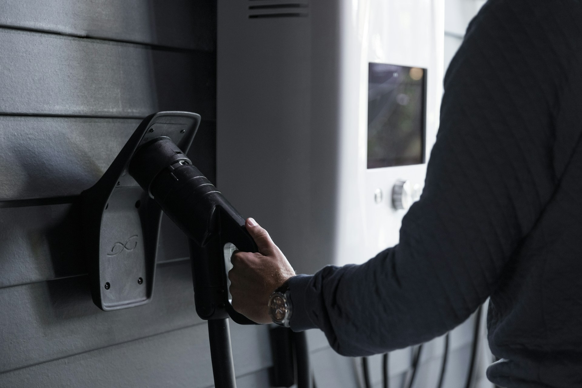 a person holding a gas pump in their hand